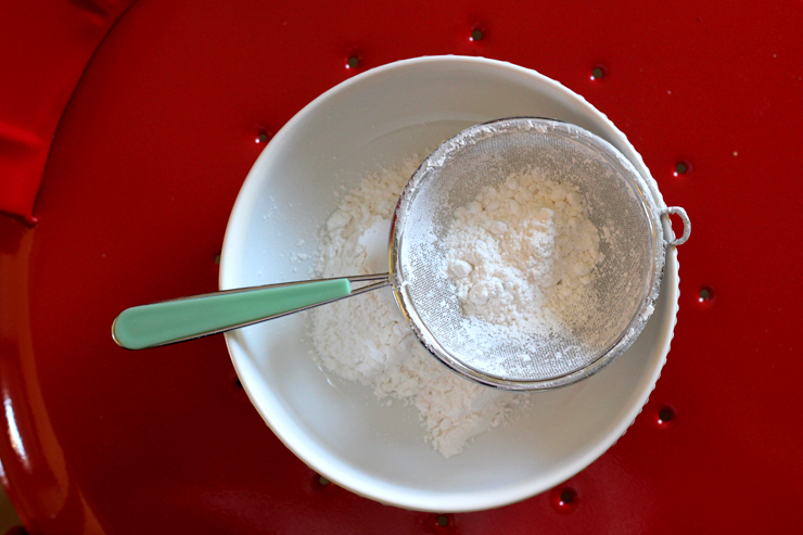 GingerMolassesPowSugar Start by sifting your powdered sugar into a medium-sized bowl.