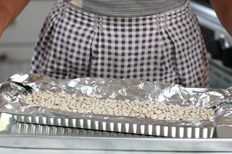 Blind baking beans for rolling tart dough for Fig Mascarpone Tart with Pistachio Black Pepper Crust dough