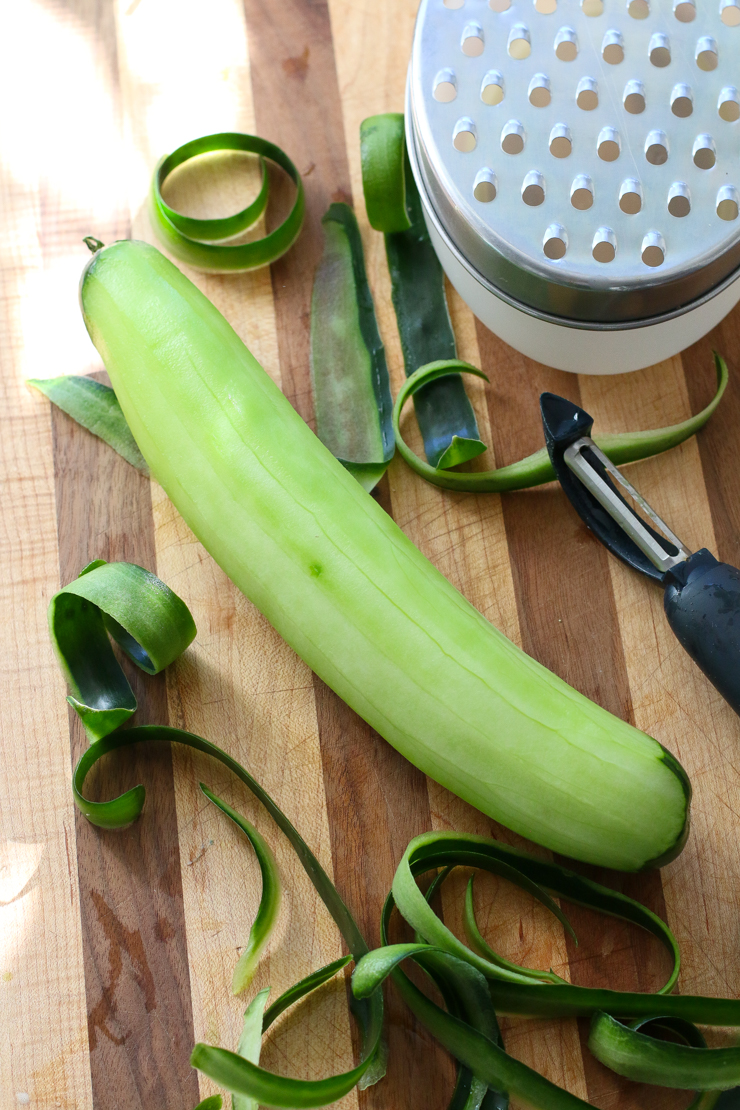 Use a vegetable peeler to peel the cucumber and then shred using a coarse cheese grater. I've had this ugly old grater from IKEA for a hundred years and I still love it.