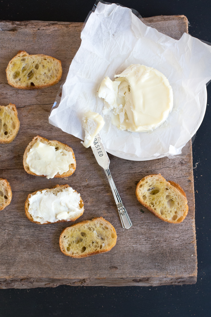assembling the Goat Cheese Apple Hazelnut & Cajeta Crostini smear goat cheese on the crostini