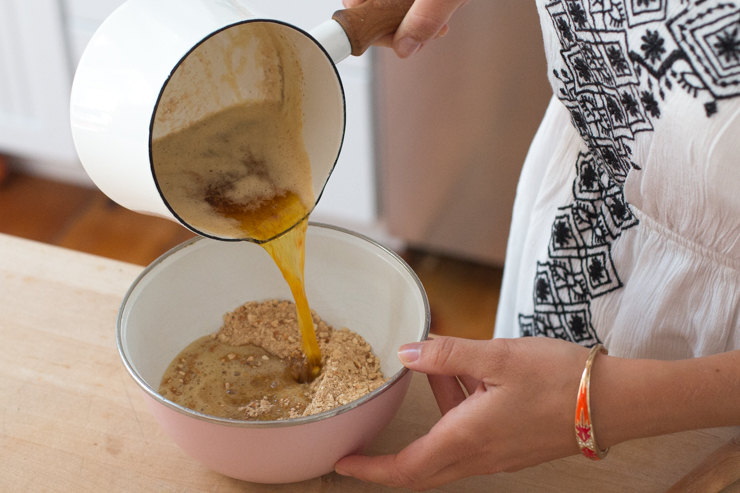 Pouring brown butter and brown sugar into the ground pretzels for the key lime tequila tart