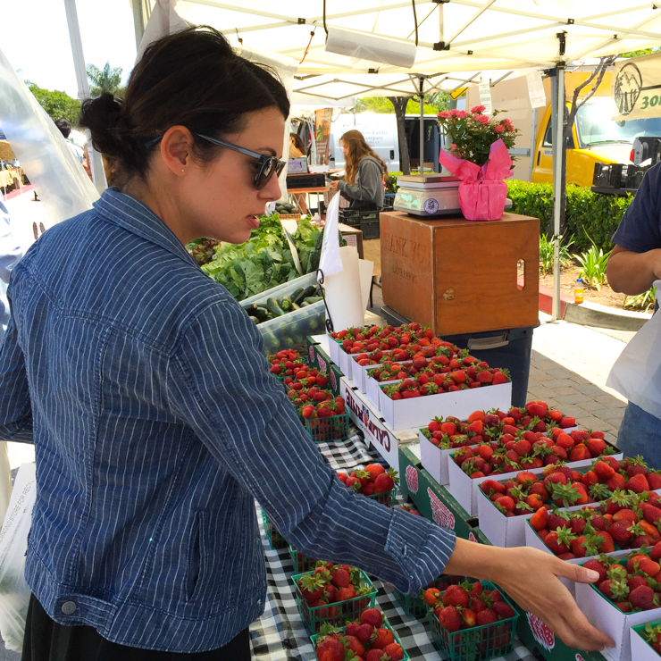 BeckySue at the farmers market buying strawberries for strawberry rhubarb ginger crumble bars