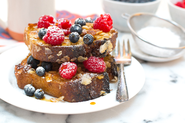 Coconut French Toast stacked with fresh berries and coconut nectar, stacked two high