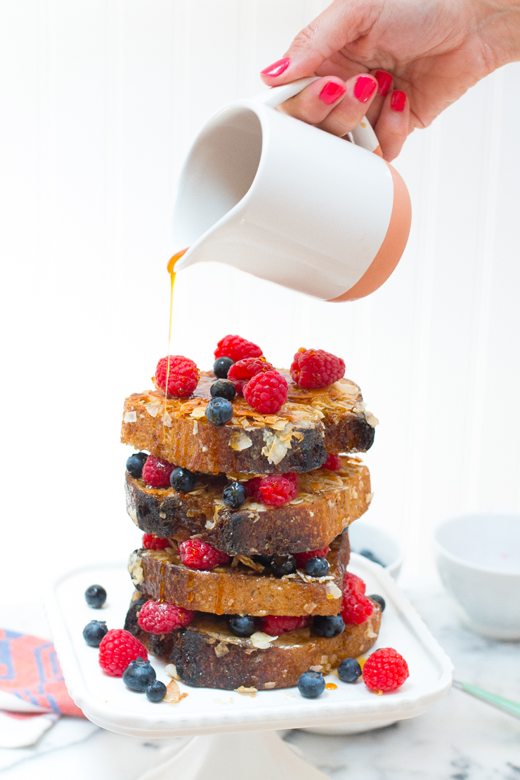 a huge stack of coconut french toast with coconut nectar