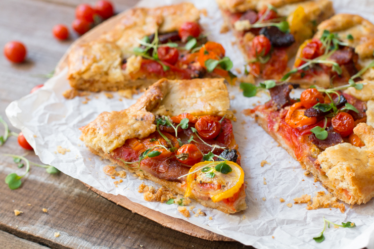 A close up of BeckySue's BLT Galette with Pecorino Pepper Crust sliced into wedges
