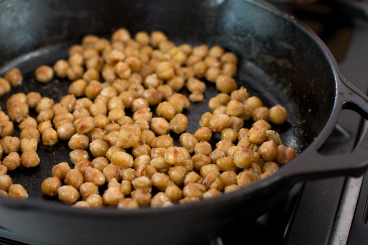 frying garbanzo beans in an iron skillet