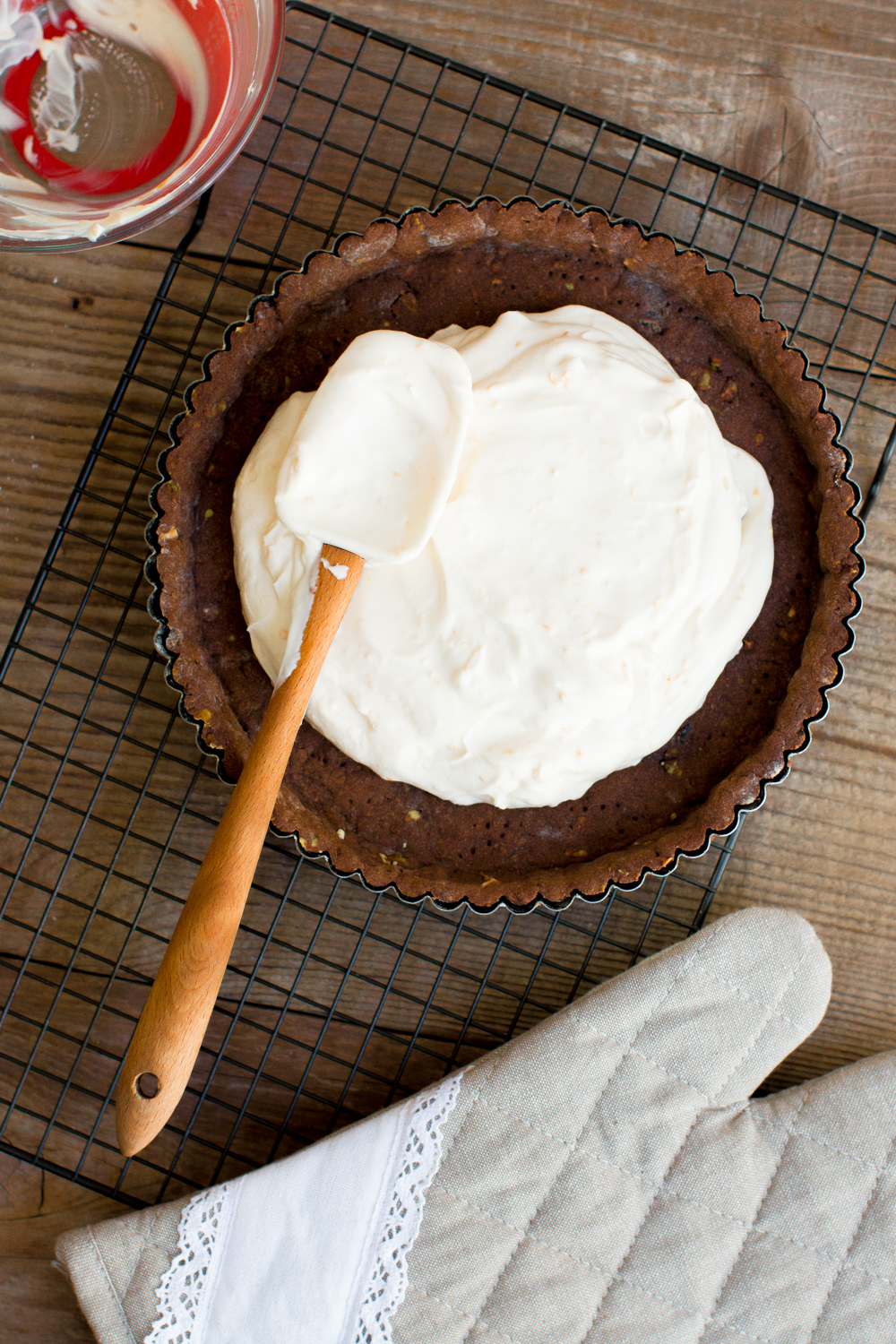 Fill the cooled chocolate pistachio tart shell evenly with the zesty mascarpone filling