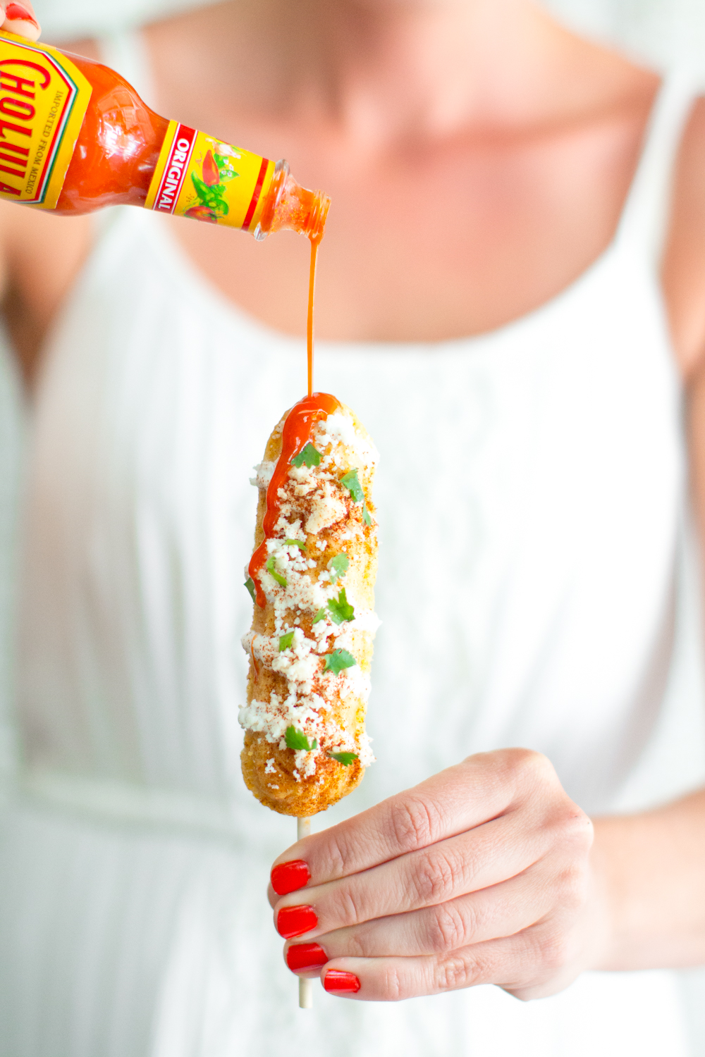 Mexican Street Cornbread On A Stick with hot sauce