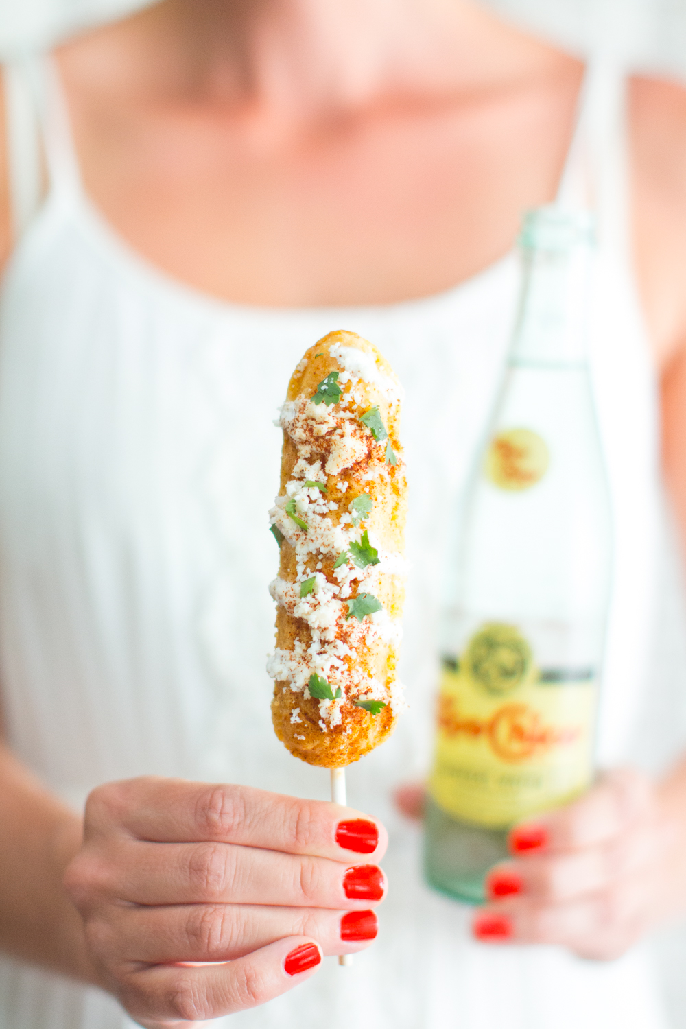 Mexican Street Cornbread On A Stick and a crisp bottle of Topo Chico