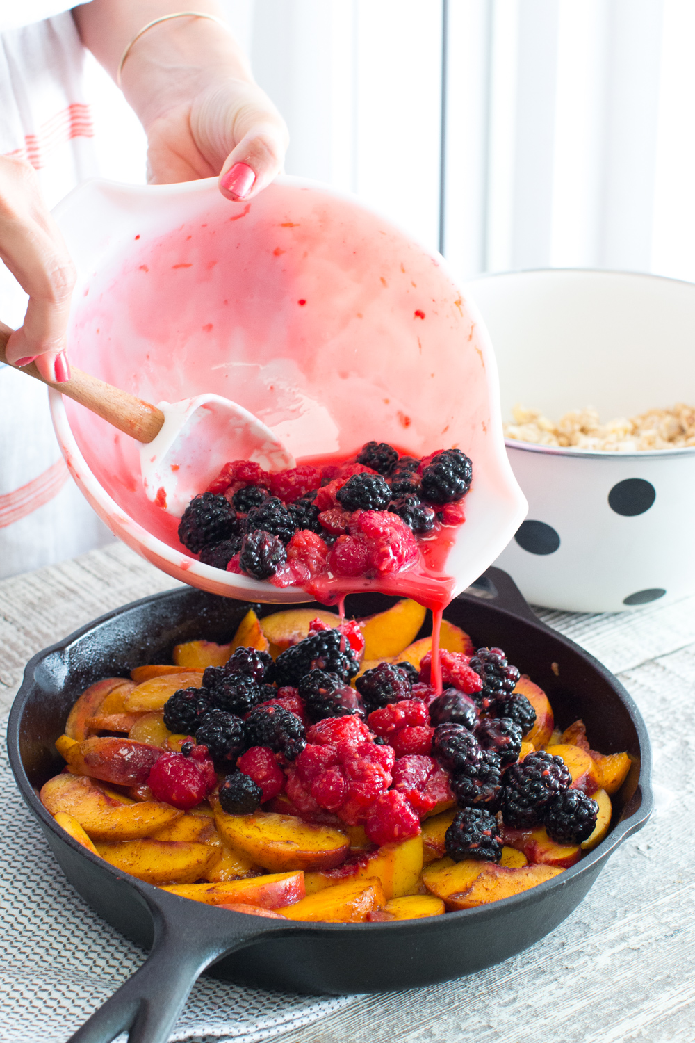 Top the peaches with the berries.