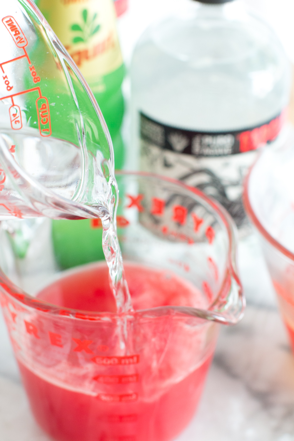 tequila pour in Watermelon Paloma Popsicles