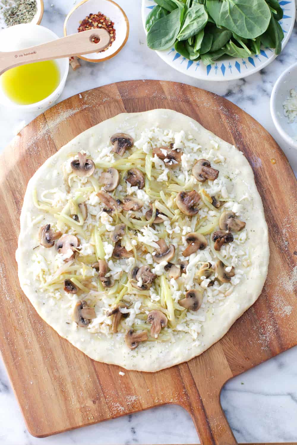 Brush the dough with olive oil, sprinkle on some oregano, top with Tillamook Mozzarella Cheese, followed by the sautéed veggie mix.