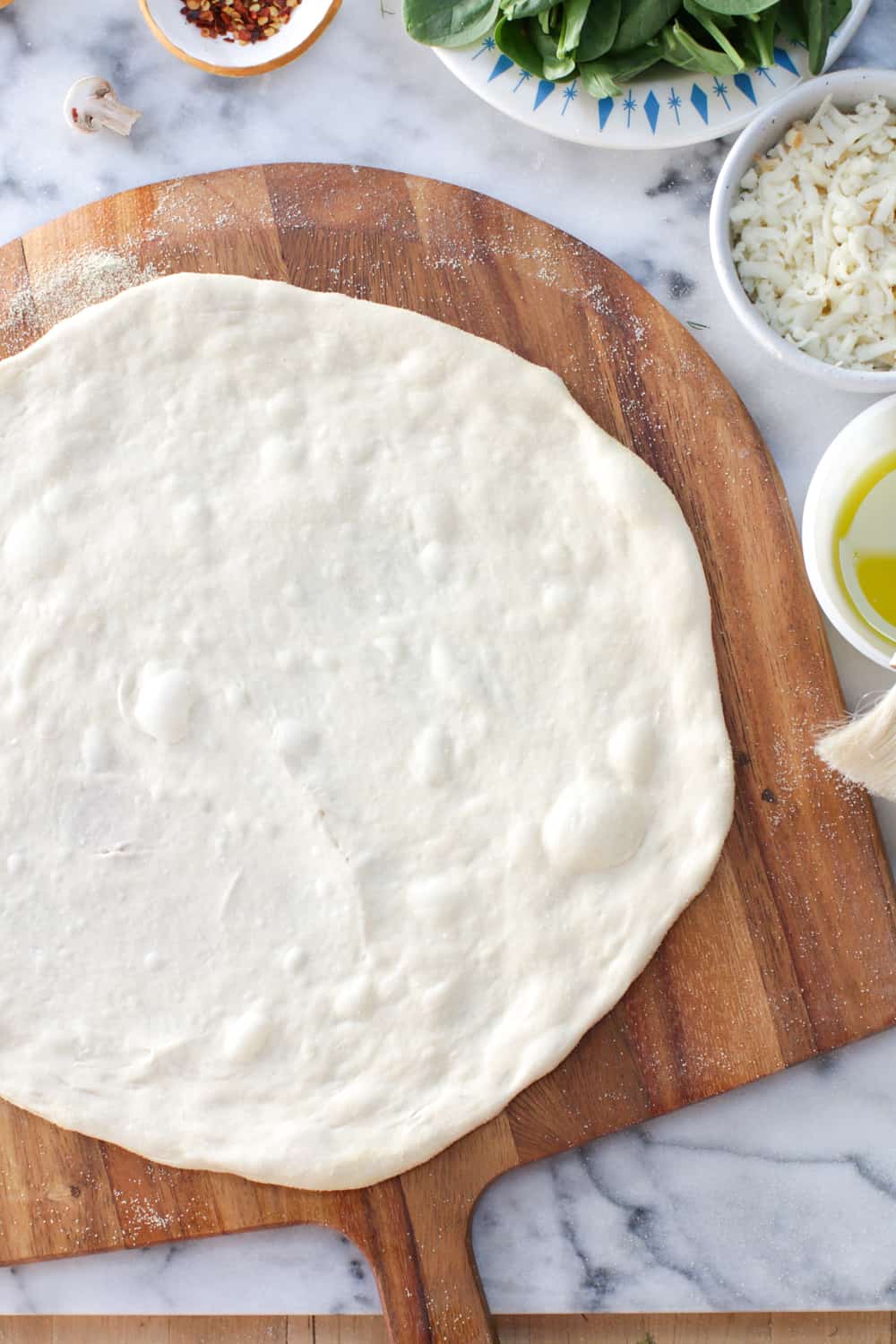 Once your dough is all stretched out on the peel, give it a nice shake to make sure it's not sticking before you start topping.