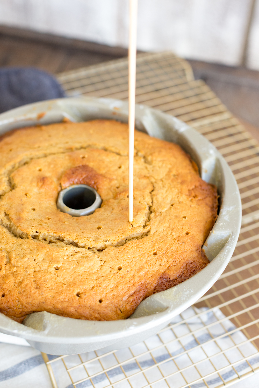 Using a skewer, poke a bunch of holes up through the cake to run the glaze all of the way up through the cake!