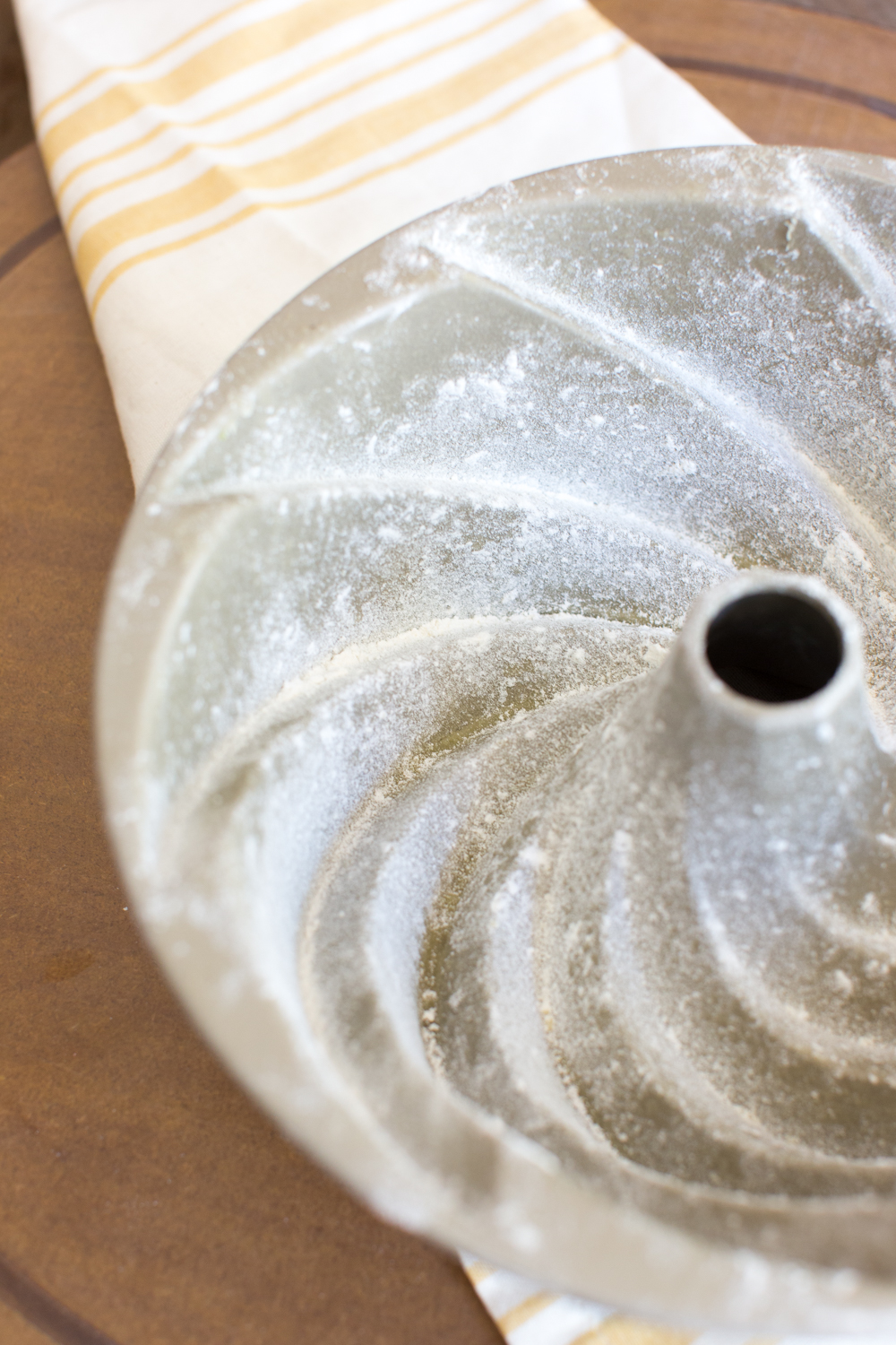 Before filling the bundt pan with batter, grease and lightly dust all of the nooks and crannies with flour.