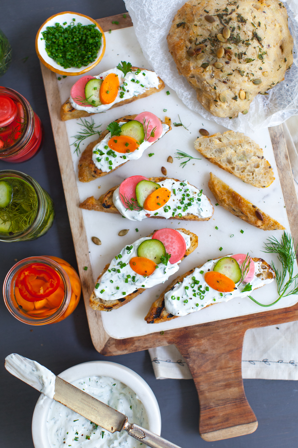 A party platter of Toast with Herbed Skyr and Quick Pickles