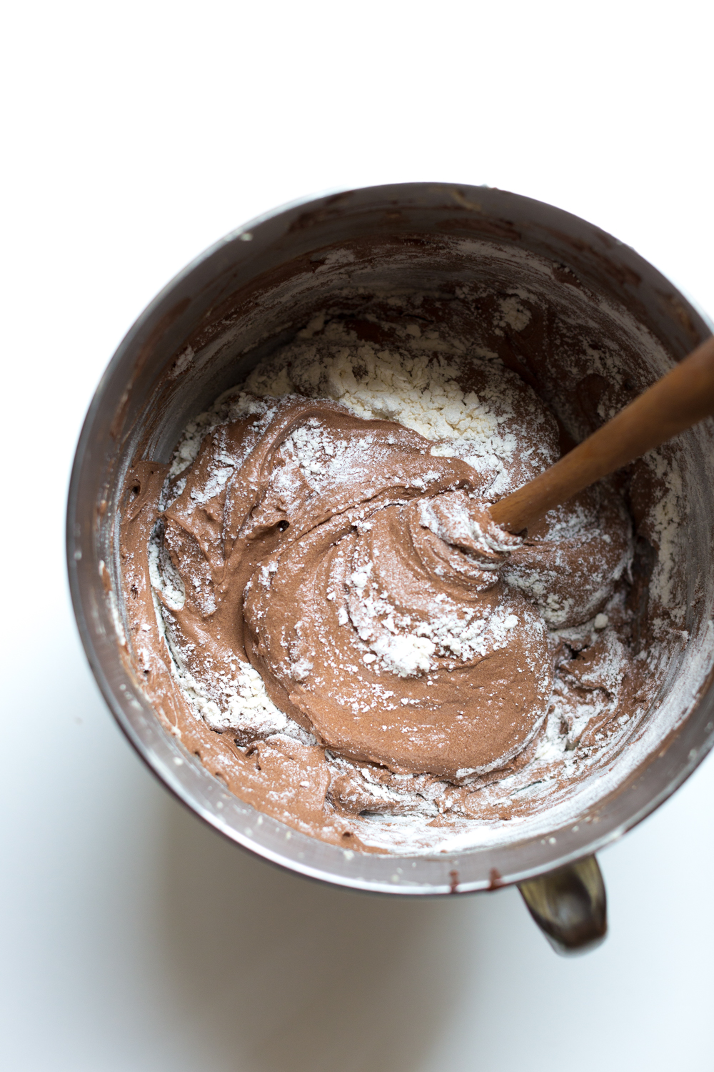 Fold the last bit of the flour mixture into the batter by hand so you don't overmix the batter.