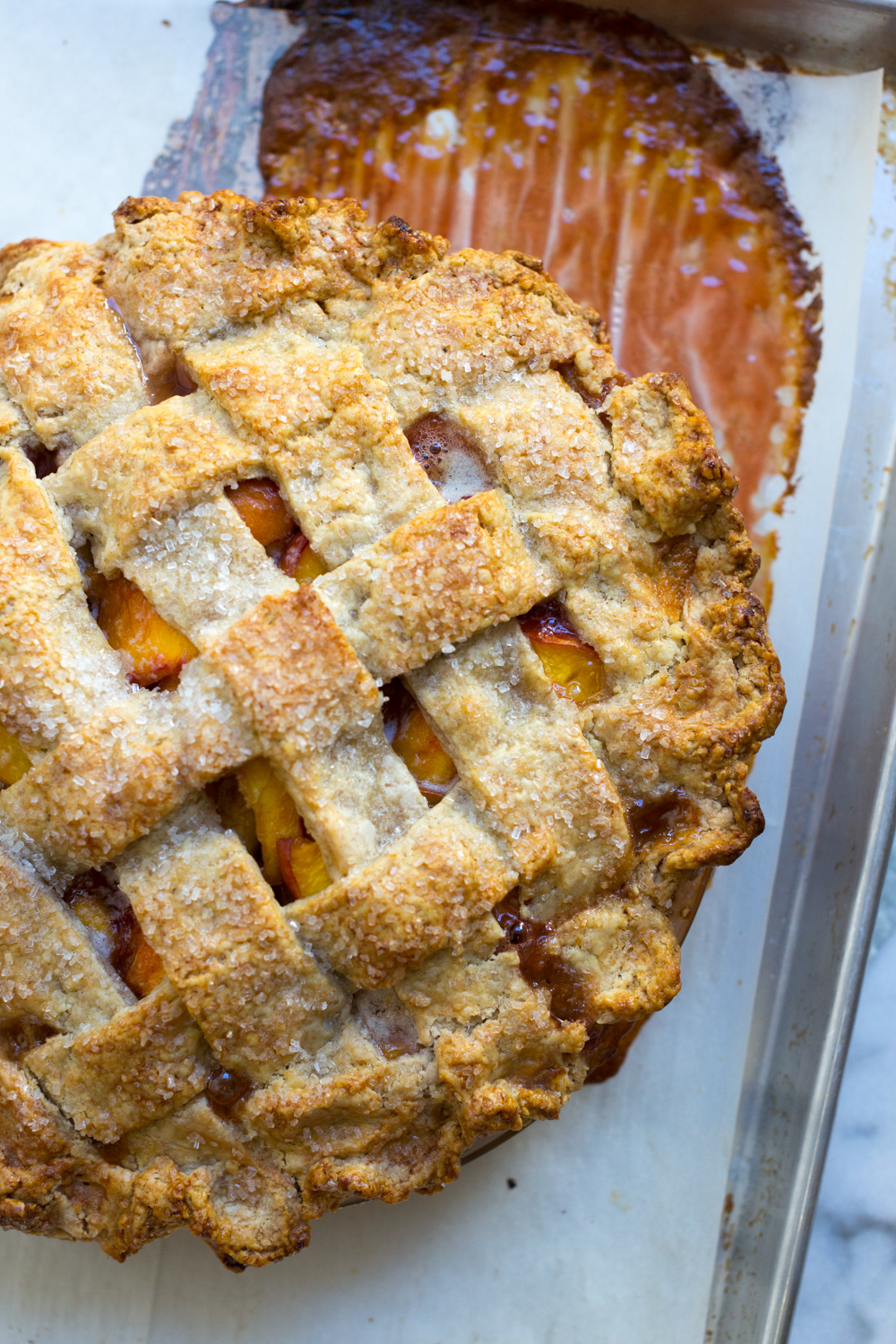 Pie after baking on a cookie sheet with filling bubbled over