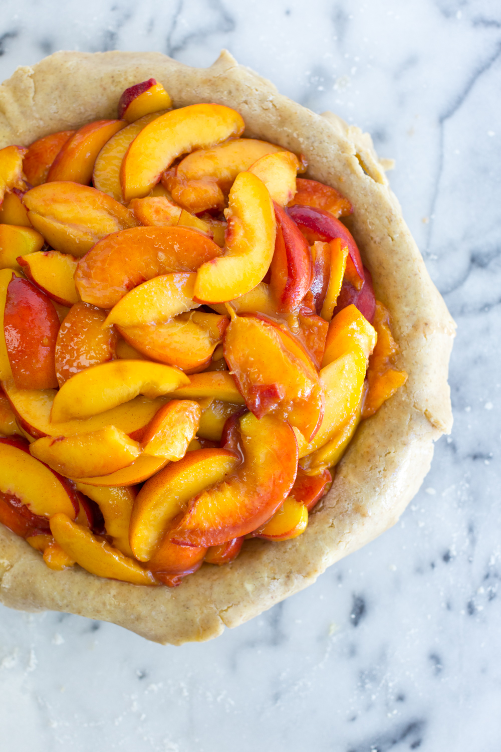 Bottom pie shell filled with the sliced peach pie filling.