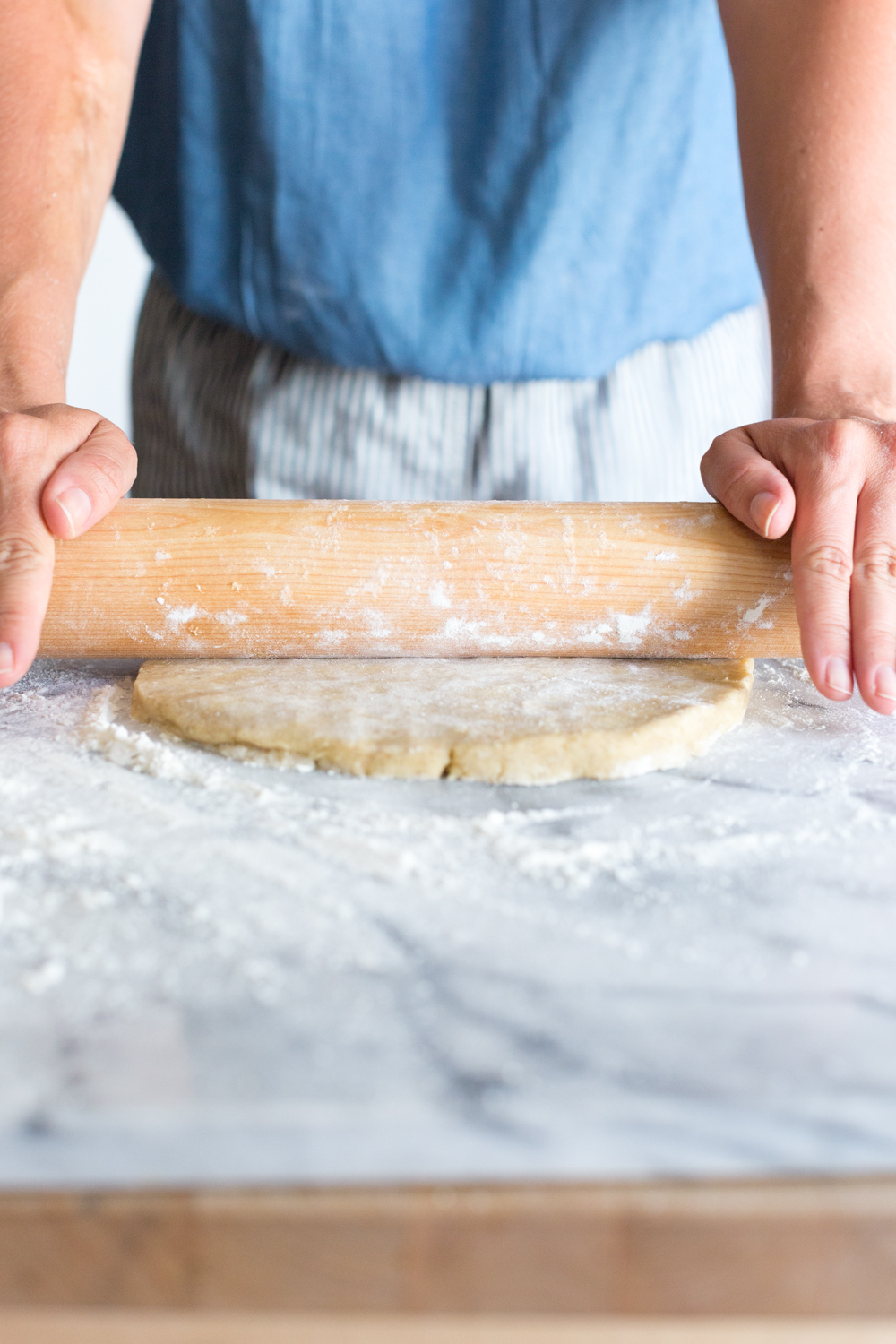 A baker rolling out rye pie dough