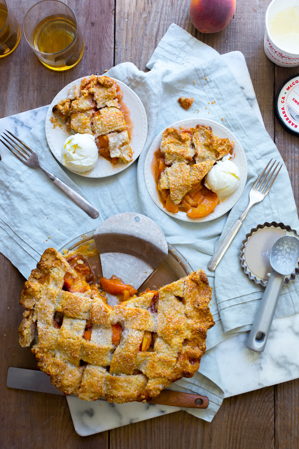 Creamy cold scoops of ice cream on thick, juicy slices of Rye Rye Peach Pie.