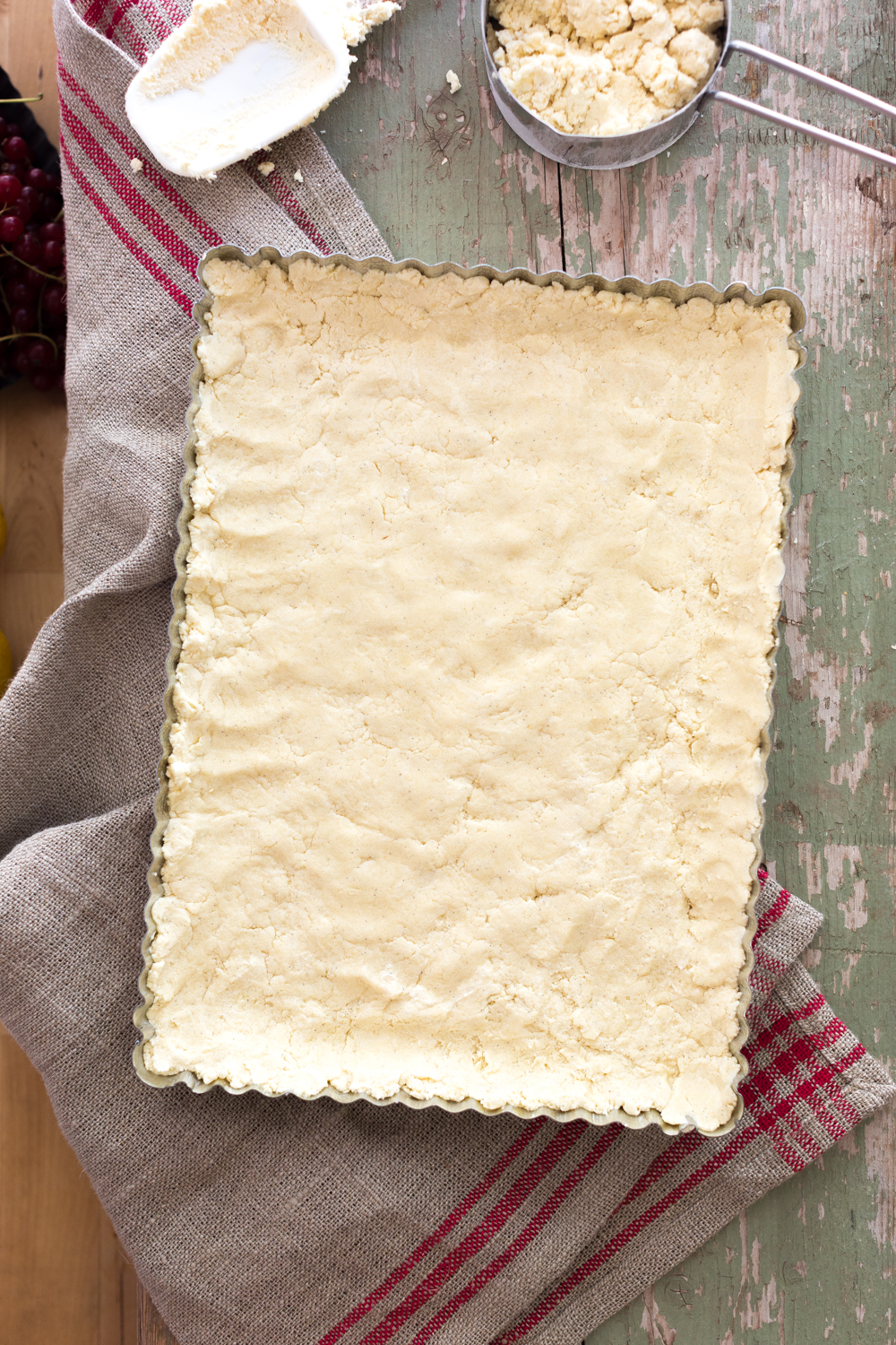 shortbread crust pressed for Red Currant Lemon Crumble Bars