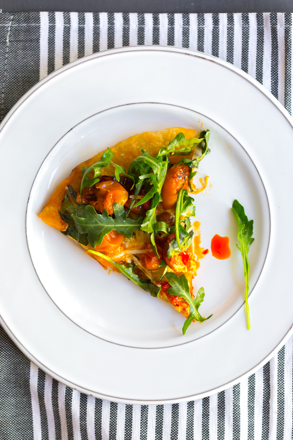 Slice of Tomato Confit Burrata and Arugula Pizza