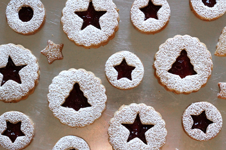 Hazelnut Linzer Cookies with wine infused jam on a metal cookie sheet