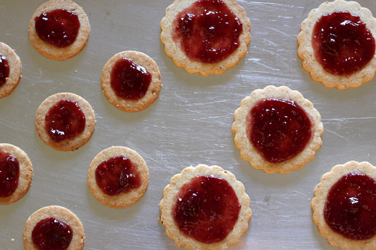 Linzer cookie bottoms with jam awaiting the top cookie