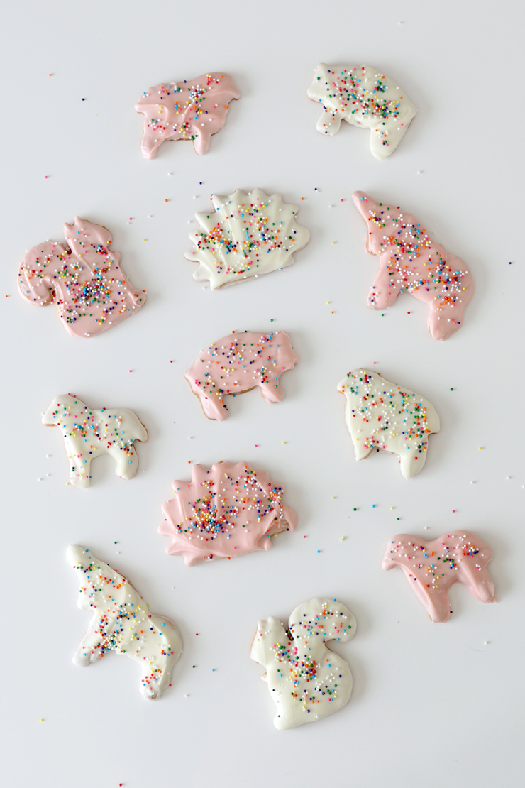 a minimal overhead shot of white and pink animal cookies with rainbow sprinkles