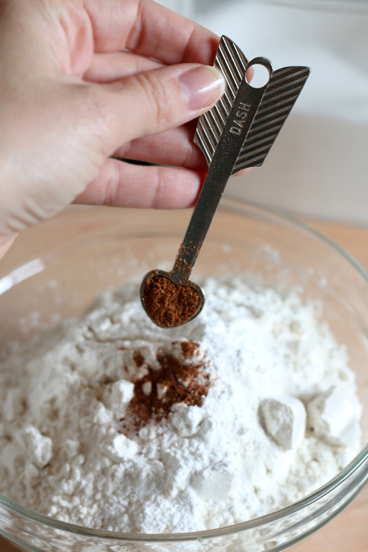 adding a dash from a small, arrow shaped, heart-tipped spoon