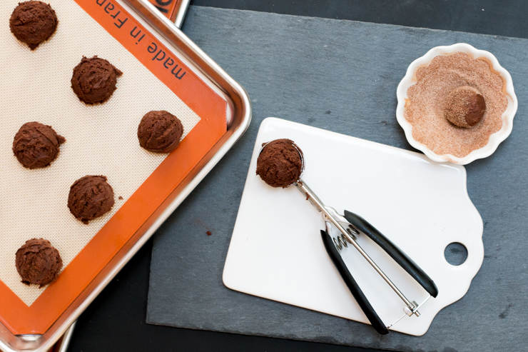 Rolling Mocha Snickerdoodles in sugar spice mix