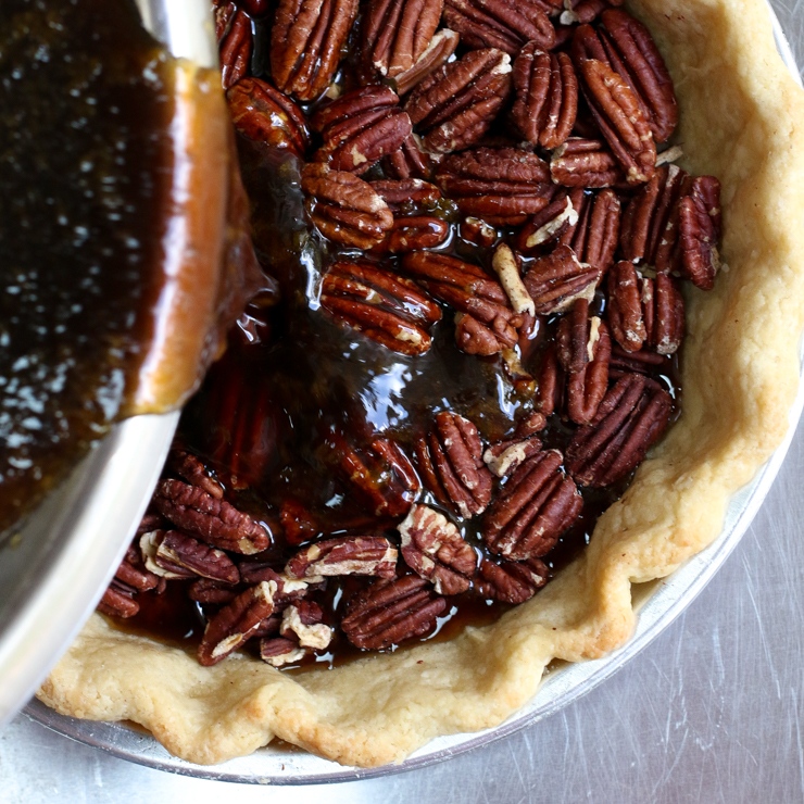 Pour the maple bourbon filling over the pecans.