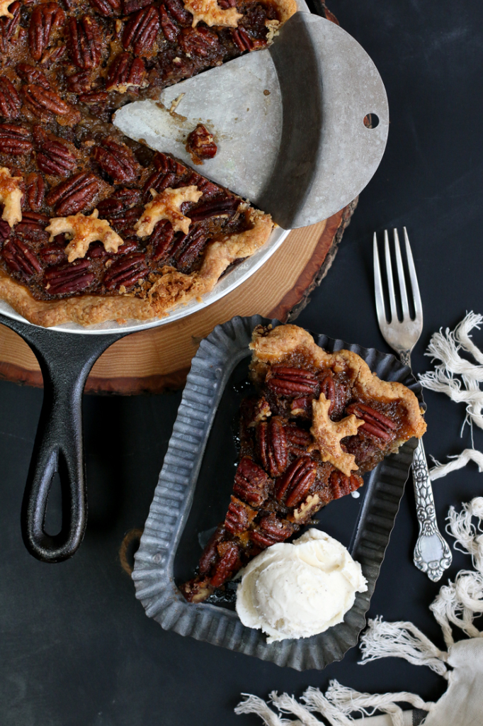 Slice of Maple Bourbon Pecan Pie with vanilla ice cream