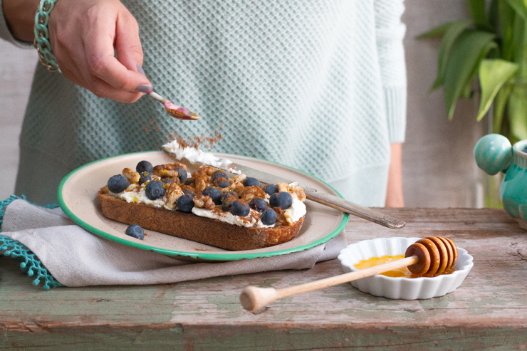 Sprinkling cinnamon on Blueberry Toast