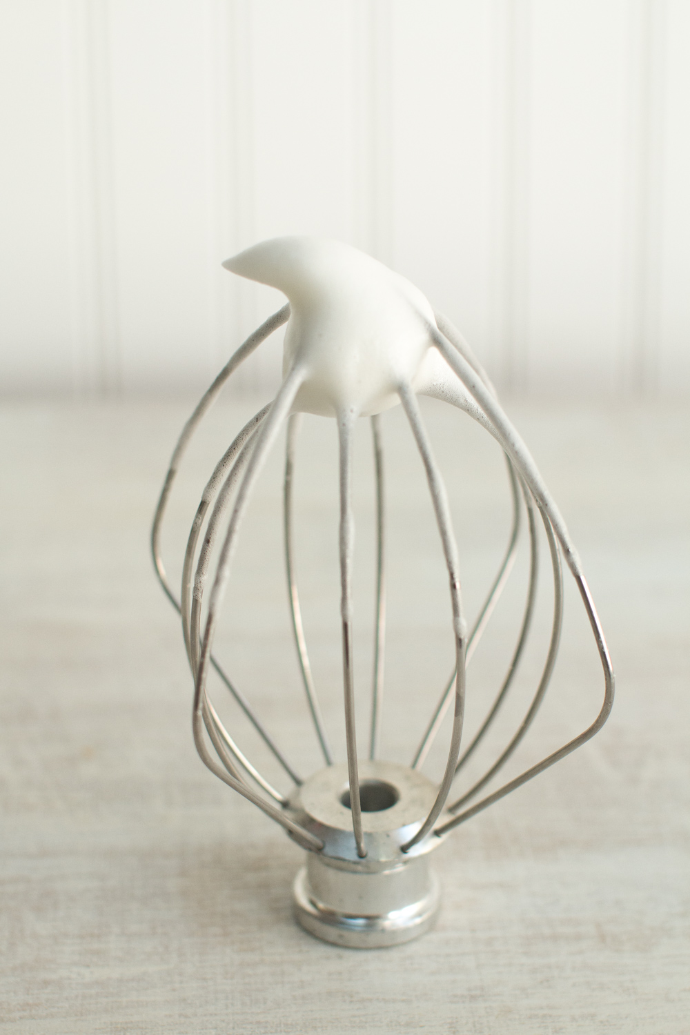 egg whites and sugar whisked together forms an airy mix that stands up at the tip of the whisk in a soft peak when placed upside down