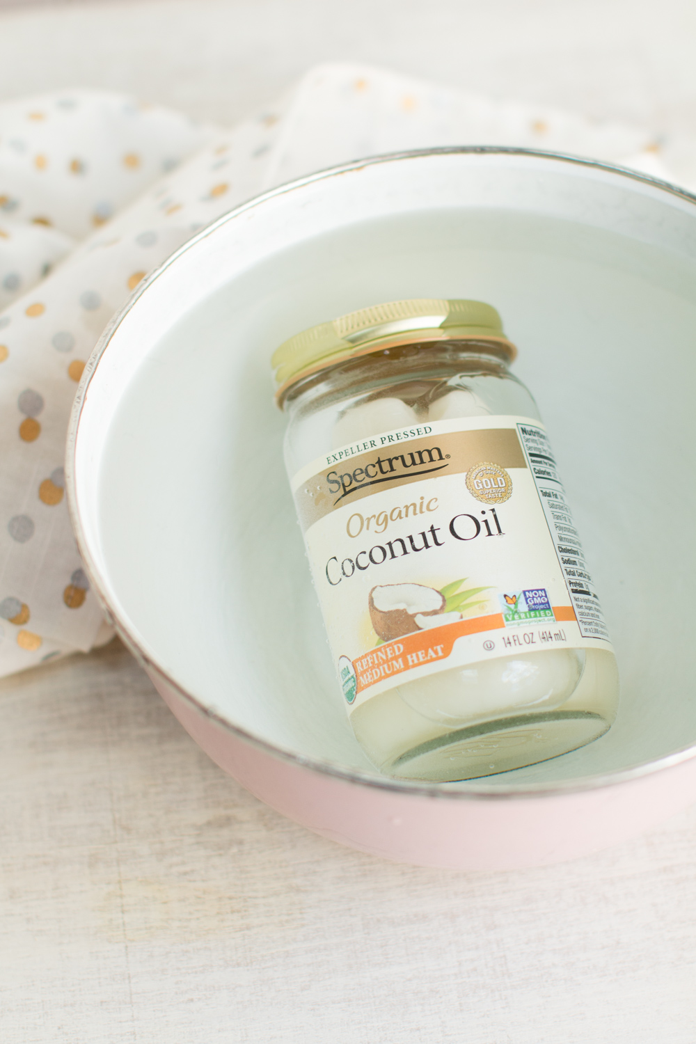 liquefy coconut oil by submerging the jar in a bowl of hot water