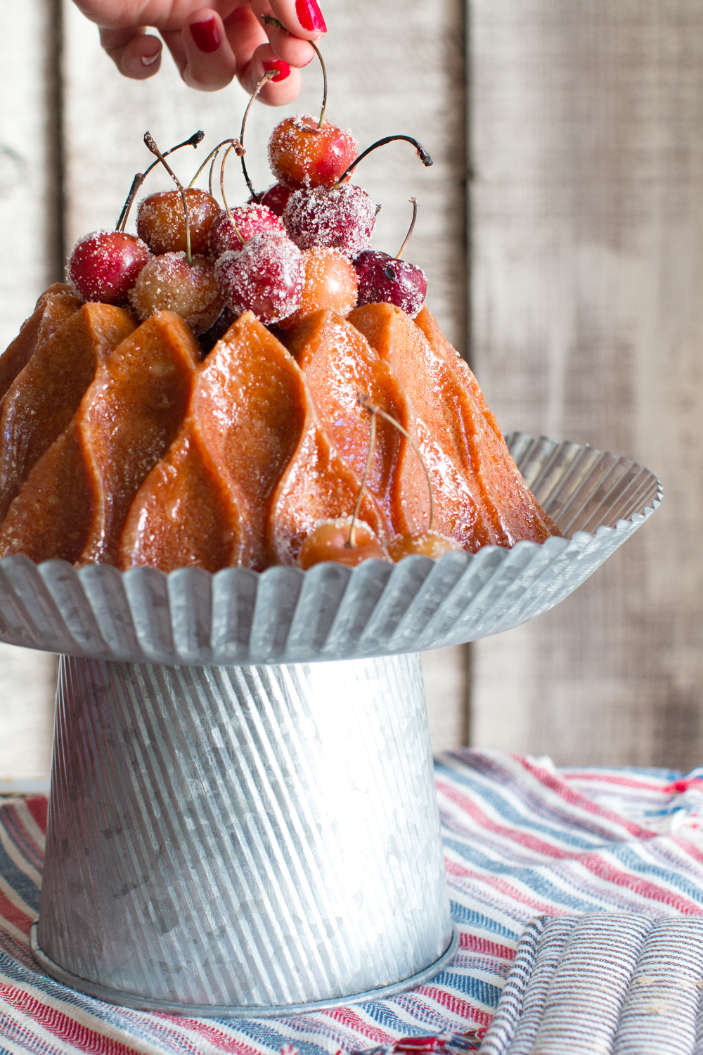 Top the brown butter bourbon bundt cake with grilled cherries