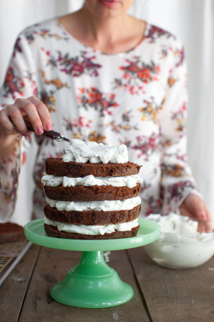 Adding whipped cream filling to chocolate mint cake
