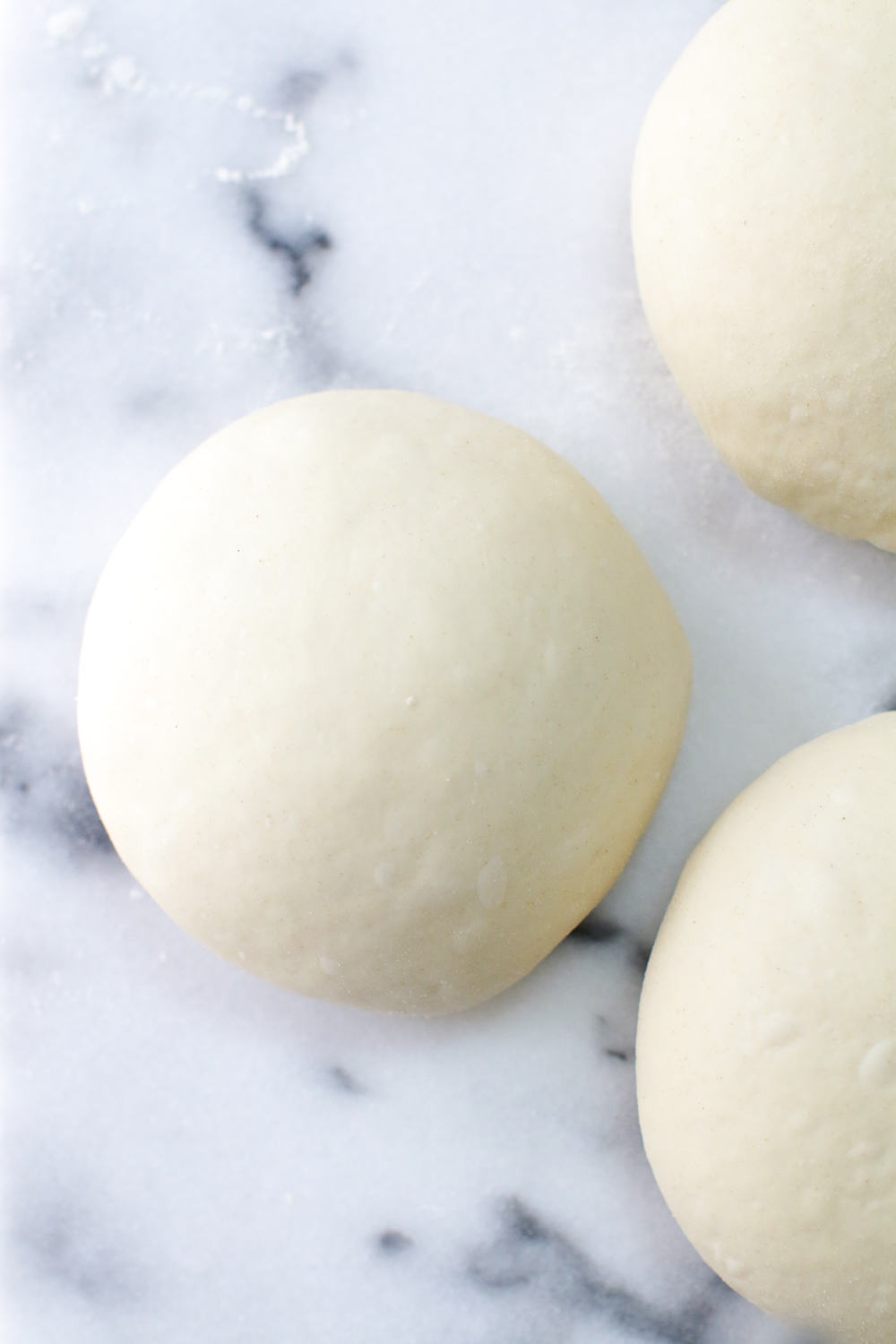 a close up of the pizza dough balls ready to chill for 48 hours