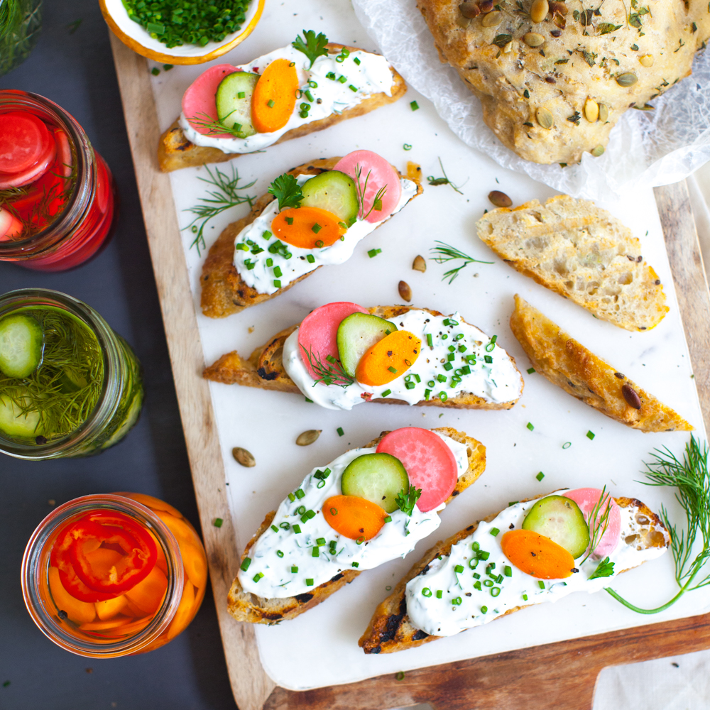 Toast with Herbed Skyr and Quick Pickles on Oat Bakery bread.