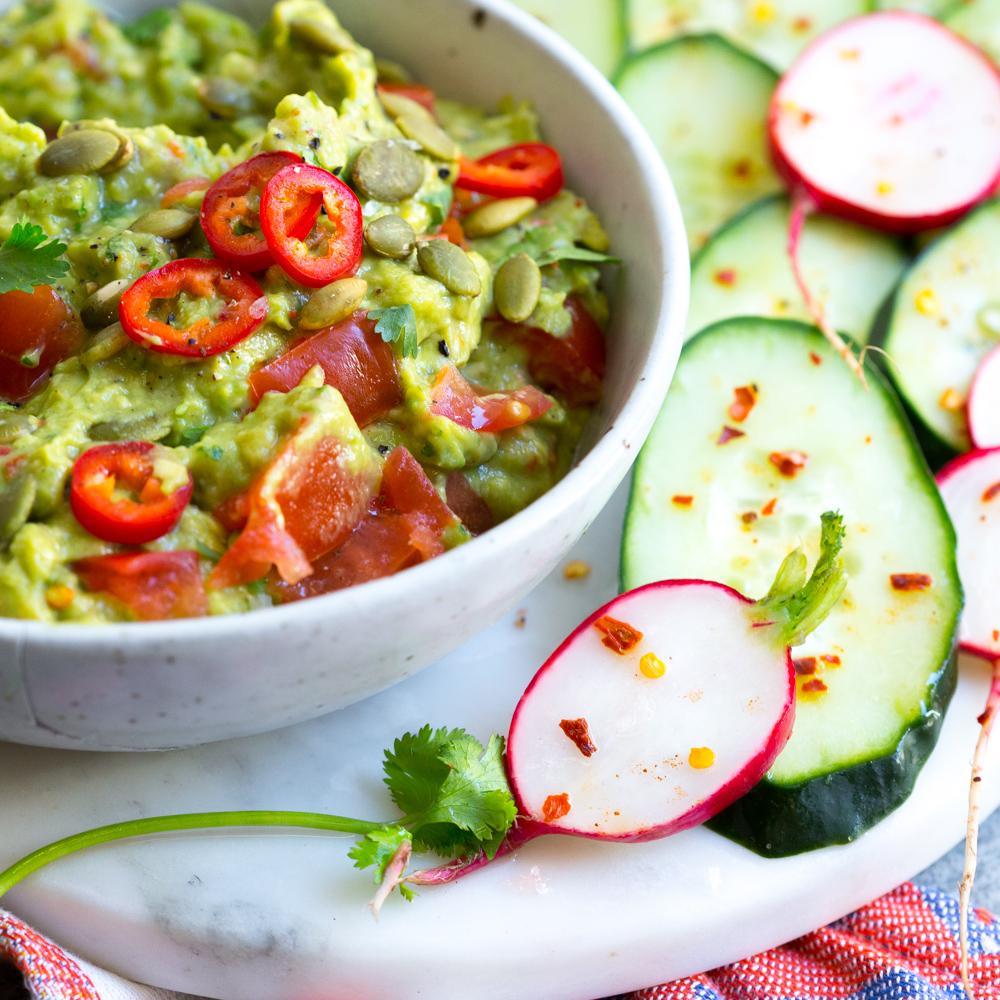Guacamole with Spicy Cucumbers and Radishes.