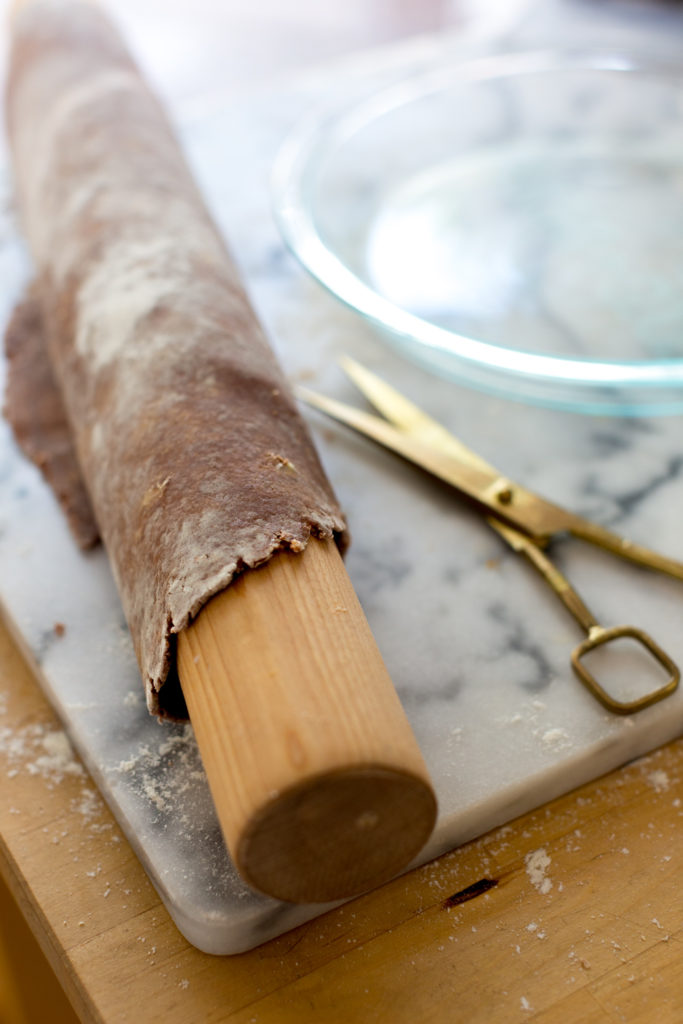 pie dough rolled around rolling pin