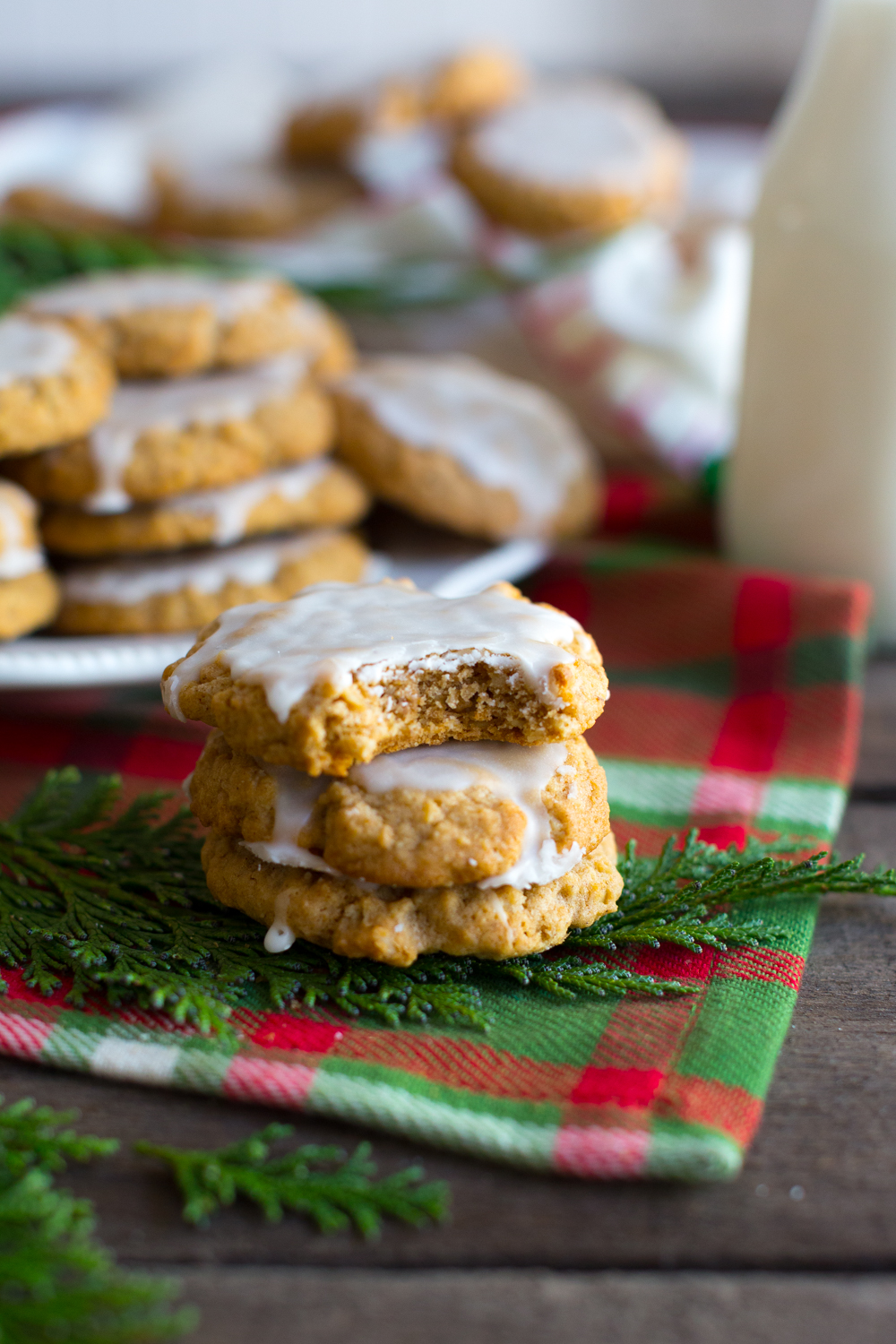 Bite of Chinese Five Spice Iced Oatmeal Cookies shows the chewy texture - angle shot with holiday decor