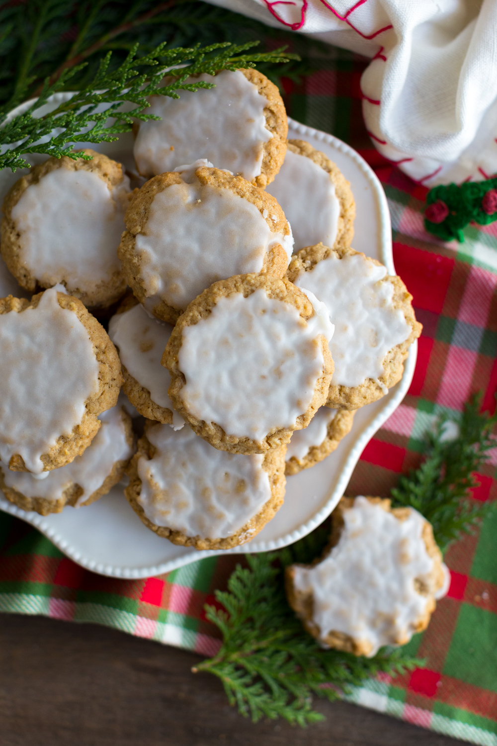 Cluttered plate of Chinese Five Spice Iced Oatmeal Cookies - overhead shot with christmas decor