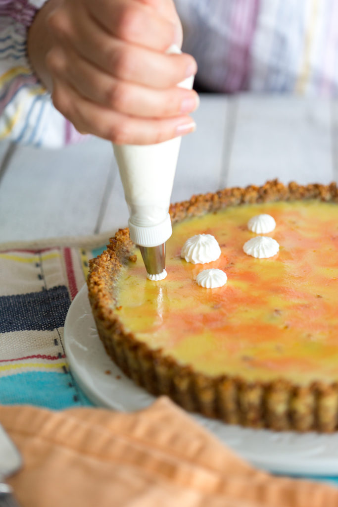 Grapefruit Margarita Tart with Pretzel Crust - piping on whipped cream