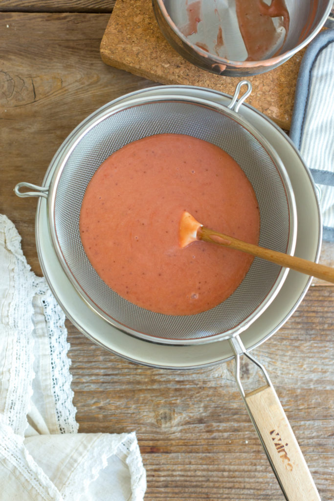 Straining curd for Strawberry Rhubarb Curd Tartlets