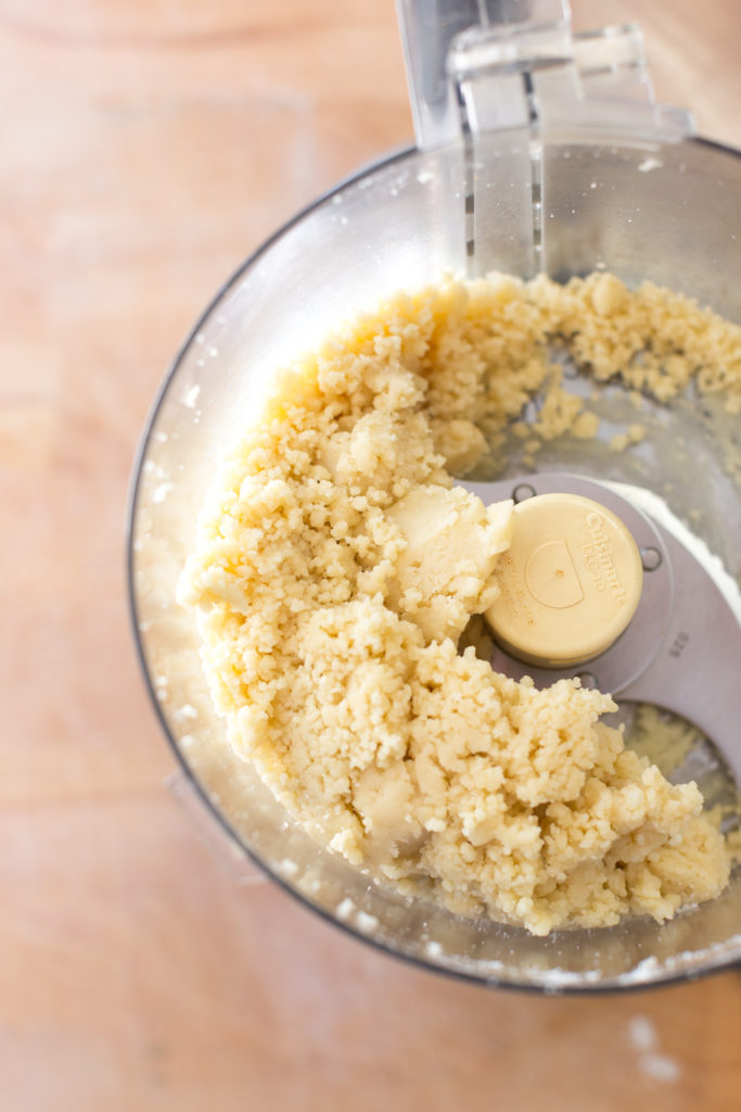 blending almond flour, powdered sugar, egg and almond extract in food processor