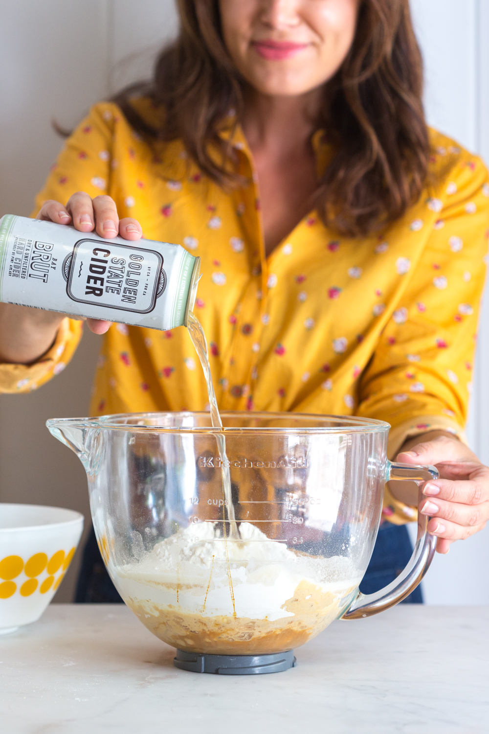 Adding cider to the Dill Pretzels with Cider Cheese Dip