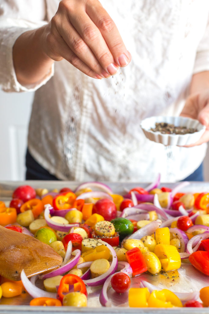 Salt and pepper on veggie chicken sheet pan meal